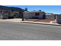 Charming single story home featuring a garage, carport, and low maintenance desert landscaping in the front yard at 460 Crestway Rd, Henderson, NV 89015