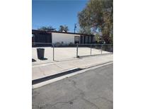 A single story home with a fenced front yard and concrete driveway at 4727 Conrad St, Las Vegas, NV 89121