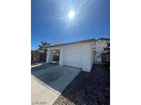 Charming single-story home featuring a two-car garage, complemented by well-maintained landscaping and desert foliage at 4795 Via San Andros, Las Vegas, NV 89103
