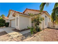Charming single-story home features a Spanish tile roof and a two-car garage at 5016 Jacarilla Ln, North Las Vegas, NV 89031