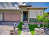 Charming single-story home with a well-manicured lawn and a welcoming brick walkway at 505 Sterling Falls Ave, Henderson, NV 89011