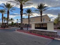 Welcoming entrance to Black Hawk gated community lined with palm trees and lush landscaping at 6316 Beige Bluff St # 201, North Las Vegas, NV 89081
