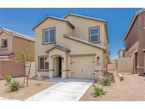 Charming two-story home featuring a tan stucco exterior, a well-manicured yard, and an attached garage at 6443 Burlap Ct, Las Vegas, NV 89122