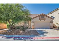 Charming one-story home featuring a well-maintained front yard and two-car garage at 7515 Splashing Rock Dr, Las Vegas, NV 89131
