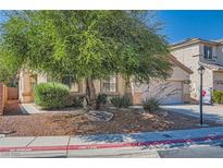 Charming home exterior with desert landscaping, mature tree, and well-maintained front yard at 7515 Splashing Rock Dr, Las Vegas, NV 89131