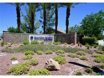 Sun City Aliante community entrance featuring mature landscaping and desert flora at 7727 Widewing Dr, North Las Vegas, NV 89084