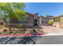 Charming single-story home featuring manicured landscaping, mature trees, and a brick driveway at 8 Via Tiberina, Las Vegas, NV 89011