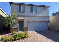 Charming two-story home with a two-car garage, stone accents, and a well-maintained front yard at 8793 Candelabra Ct, Las Vegas, NV 89148