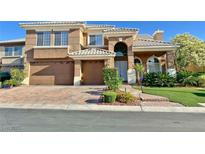 Charming two-story home boasts a three-car garage and meticulously landscaped front yard at 8931 Lansberry Ct, Las Vegas, NV 89147