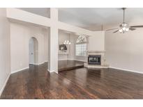 Bright living room with hardwood floors, fireplace, and neutral paint at 9305 Hollycrest Dr, Las Vegas, NV 89117
