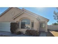 Charming single-story home with arched window, desert landscaping, and a well-maintained front yard at 1325 Fiesta Grande Ct, North Las Vegas, NV 89031