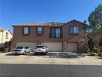 Inviting two-story townhome featuring multiple garages and a balcony at 1355 Grass Creek Ave # 1, Henderson, NV 89012