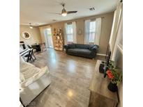 Spacious living room featuring a ceiling fan, modern furniture, and plenty of natural light at 1355 Grass Creek Ave # 1, Henderson, NV 89012
