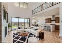 Open-concept living space with a modern kitchen, plush seating, and seamless indoor-outdoor flow at 182 Robledo St, Las Vegas, NV 89138