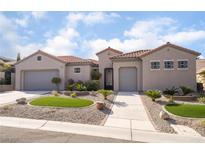 Charming single-story home showcasing a desert landscape, a neutral color palette, and a terracotta tile roof at 2365 Black River Falls Dr, Henderson, NV 89044