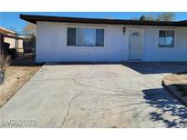 View of the front exterior, featuring a paved driveway leading to the white single-story home at 2564 San Marcos St, Las Vegas, NV 89115