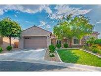 Charming single-story home with desert landscaping, a spacious driveway, and a two-car garage at 2785 Rosenhearty Dr, Henderson, NV 89044