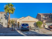 Charming single-story home with desert landscaping, mature palm tree, and attached two-car garage at 320 Ellen Marie Dr, Las Vegas, NV 89110