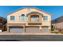 Multi-level townhouse featuring a private balcony and three individual one-car garages at 3609 Indigo Flower St # 1, North Las Vegas, NV 89084