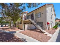 Charming condo with stucco exterior, red tile roof, and inviting staircase to the second level entrance at 3609 Melonies Dr # 93, Las Vegas, NV 89103