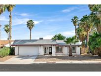 Charming single-story home featuring a well-maintained yard and palm trees under a clear blue sky at 3849 Boca Chica Ave, Las Vegas, NV 89120