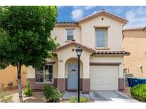 Charming two-story home with stucco exterior, a blue front door, desert landscaping, and attached garage at 4249 Fleet Dancer St, Las Vegas, NV 89129