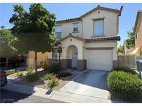 Charming two-story home featuring a well-maintained lawn, inviting blue door, and a convenient attached garage at 4249 Fleet Dancer St, Las Vegas, NV 89129