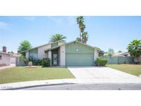Charming single-story home featuring a well-manicured lawn and an attached two-car garage at 4409 Rosebank Cir, Las Vegas, NV 89108