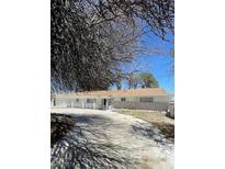 Charming ranch-style home featuring a long, covered porch and a stone accent wall at 4560 Rancho Hills Dr, Las Vegas, NV 89119