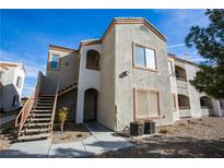 A stucco two-story condo building with stairs up to the second floor and desert landscaping at 4655 Gold Dust Ave # 206, Las Vegas, NV 89120