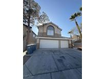 Two-story home featuring a three-car garage and desert landscaping at 5115 Blossom Ave, Las Vegas, NV 89142