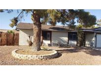 Cozy home featuring neutral stucco exterior and a tree in the front yard at 5284 Wellesley Ave, Las Vegas, NV 89122
