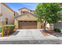 Inviting home exterior with a manicured lawn, large trees, and a two-car garage at 5452 Tinker Toy Ave, Las Vegas, NV 89139