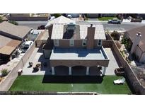 A charming home featuring a patio, a backyard with a manicured lawn, and elegant landscaping at 7197 Sixshooter Dr, Las Vegas, NV 89119