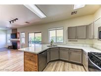 Bright kitchen features a center island, stainless steel appliances, and ample countertop space at 7900 Dutch Canyon Ct, Las Vegas, NV 89131