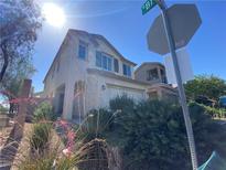 Two-story home featuring stucco siding, desert landscaping, and an attached two-car garage at 8566 Bright Bush St, Las Vegas, NV 89131