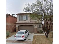 Two-story home with a two-car garage and neutral stucco exterior at 8695 Canfield Canyon Ave, Las Vegas, NV 89178