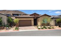 Charming single-story home featuring a well-manicured front yard with desert landscaping and a two-car garage at , Henderson, NV 89011
