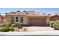 Charming single-story home with a well-manicured front yard and a tile roof at , North Las Vegas, NV 89084