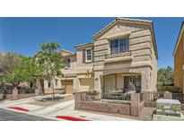 Charming two-story home featuring a covered porch, lovely landscaping, and an attached garage at 10456 Prairie Schooner Ave, Las Vegas, NV 89129