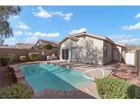 Sparkling pool with well maintained landscaping in the backyard of home at 11076 Zampino St, Las Vegas, NV 89141