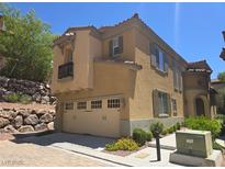 Two-story home with a neutral color scheme, two-car garage, and desert landscaping at 11298 Corsica Mist Ave, Las Vegas, NV 89135