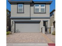 Charming two-story home featuring a gray exterior, garage, and a paved driveway at 12525 Lylan Ridge St, Las Vegas, NV 89138