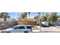 Cozy single-story home with a brown roof, desert landscaping, and a welcoming wooden front facade at 158 Palisade Ave, Las Vegas, NV 89110