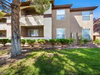 Beautiful multi-level condo building with well-manicured landscaping, green lawn, and fresh curb appeal at 231 W Horizon Ridge Pkwy # 212, Henderson, NV 89012
