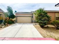 Charming single-story home featuring a two-car garage and low maintenance desert landscaping at 2633 Spider Cactus Ct, Las Vegas, NV 89106