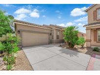 Charming single-story home featuring a two-car garage, desert landscaping, and a well-maintained front yard at 2633 Spider Cactus Ct, Las Vegas, NV 89106