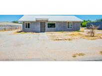 Charming single-story home with a gray stucco exterior and a metal roof at 280 Gentry St, Overton, NV 89040