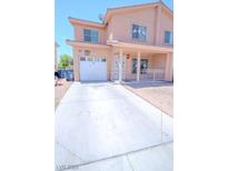 Two-story home with covered porch, white garage door and easy to maintain desert landscaping at 2906 Cedar Ave, Las Vegas, NV 89101