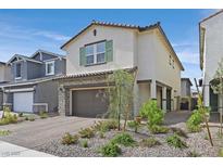 Charming two-story home featuring a stone accented facade and a well-manicured front yard at 392 Canary Song Dr, Henderson, NV 89011